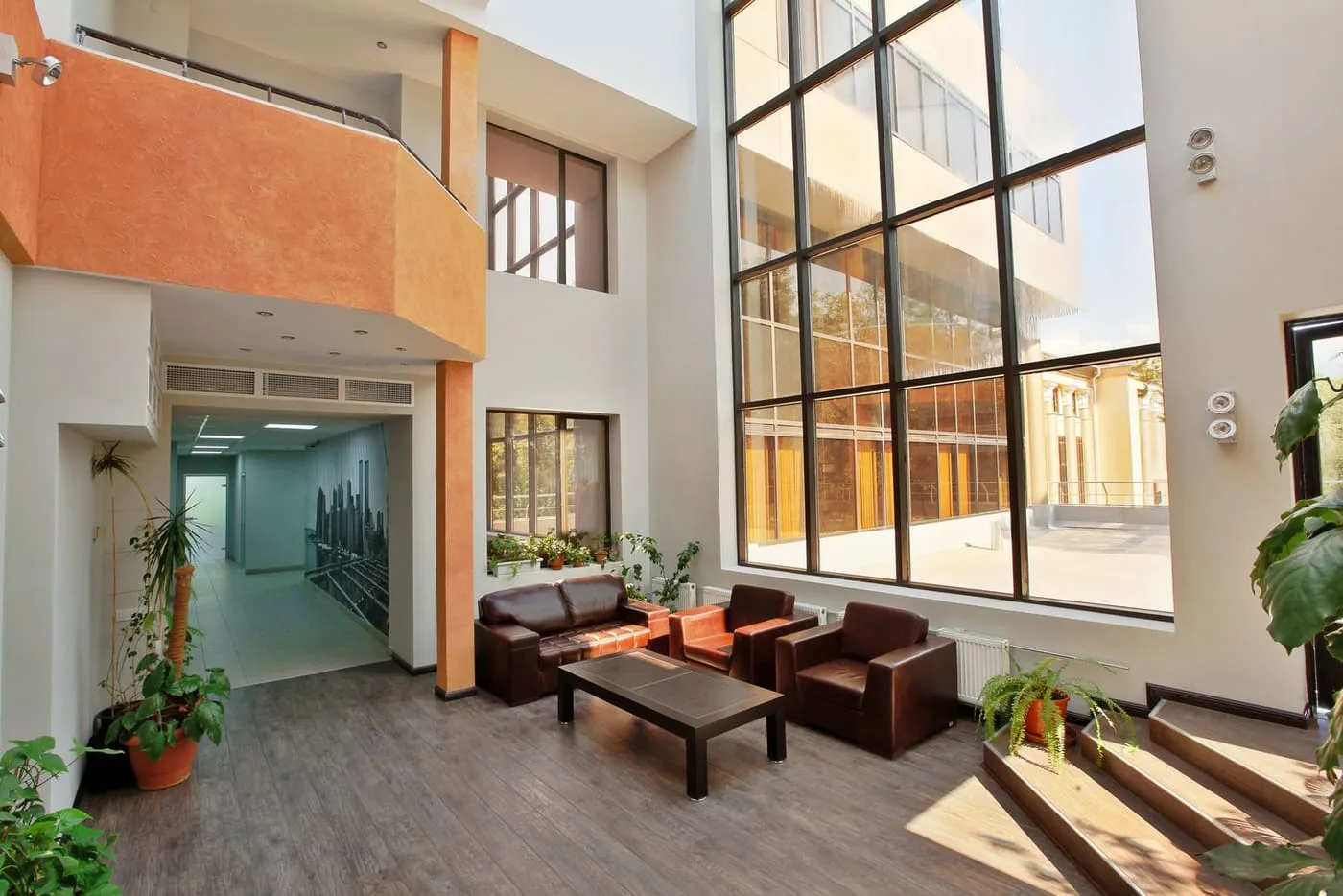 A shared atrium walkway with seating areas and natural light