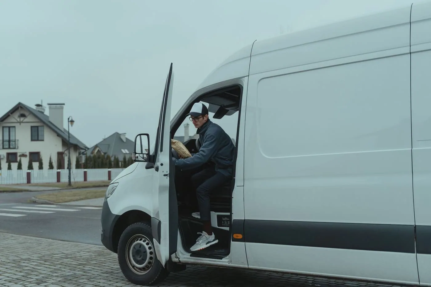 A courier van parked on a residential street during a delivery route